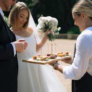 brinde and groom eating from a canape board | Photo credit: Courtney Marie Photographer brinde and groom eating from a canape board | Photo credit: Courtney Marie Photographer